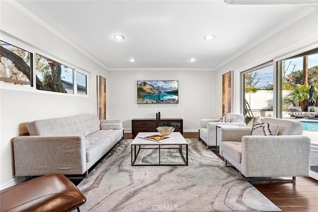 living room featuring recessed lighting, ornamental molding, baseboards, and wood finished floors