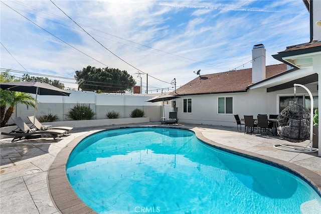 view of pool with a patio, fence, and a fenced in pool