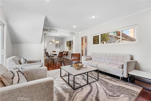 living room featuring visible vents, wood finished floors, recessed lighting, crown molding, and a chandelier