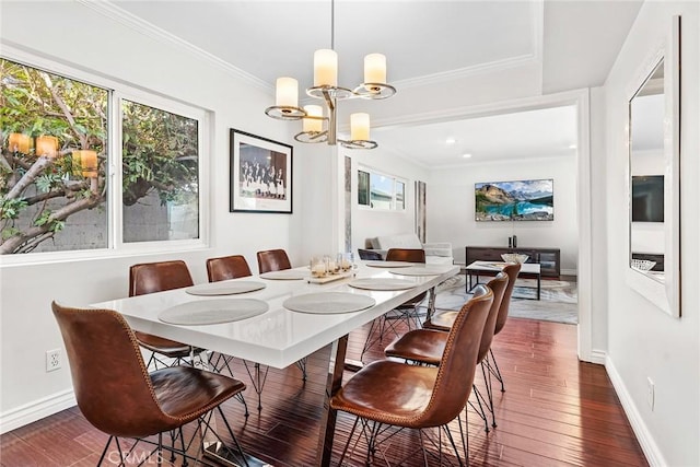 dining space featuring dark wood-style floors, baseboards, a chandelier, and ornamental molding