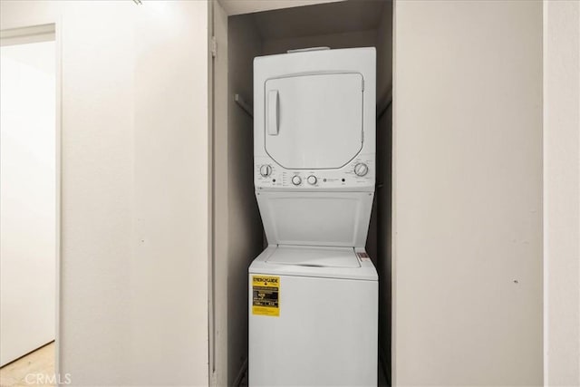 washroom featuring laundry area and stacked washer / dryer