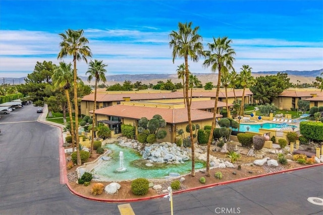 birds eye view of property with a mountain view