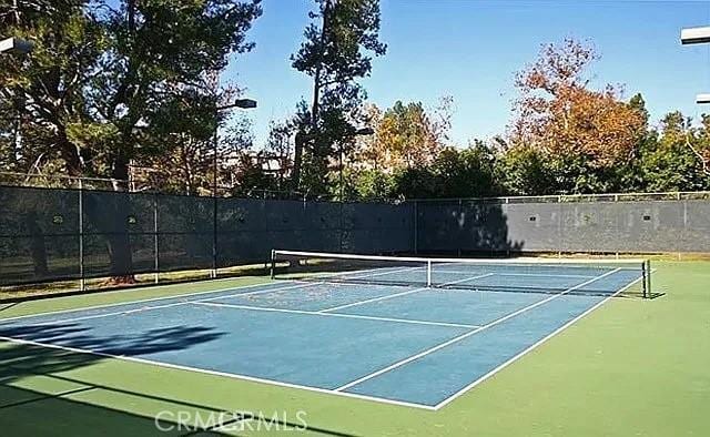 view of tennis court with fence