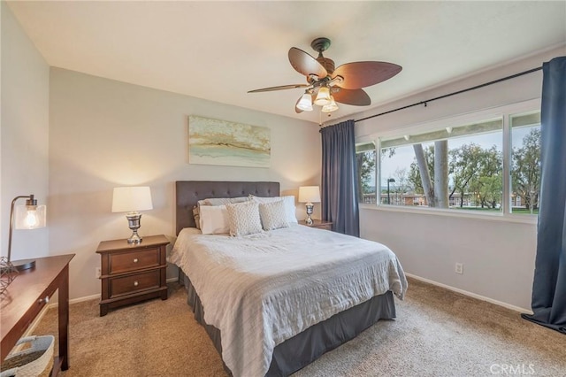 carpeted bedroom featuring a ceiling fan and baseboards