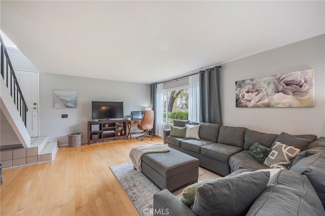 living room with stairway and light wood-style floors