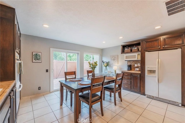 dining room with recessed lighting, visible vents, baseboards, and light tile patterned floors