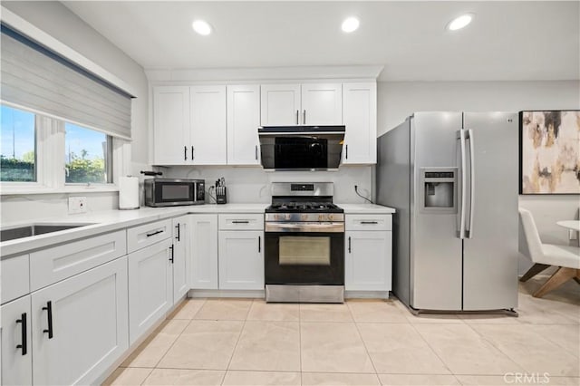 kitchen featuring light countertops, appliances with stainless steel finishes, white cabinetry, and recessed lighting