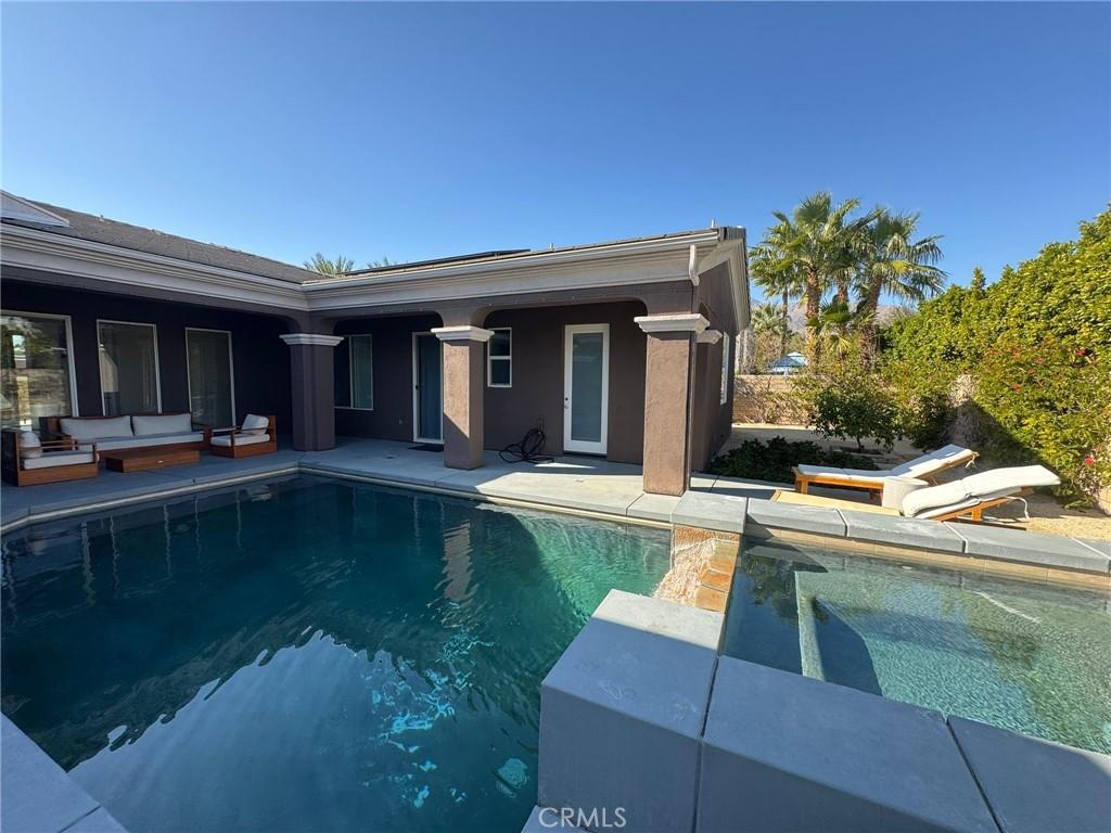 outdoor pool featuring a patio area and an outdoor hangout area