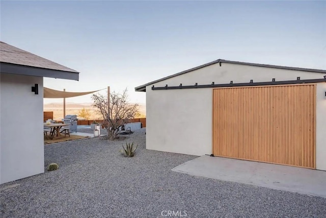 exterior space with a patio area and stucco siding