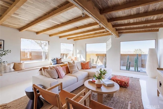 sunroom / solarium with vaulted ceiling with beams, wooden ceiling, and rail lighting