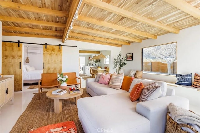 living room with a barn door, beamed ceiling, wooden ceiling, and a wealth of natural light