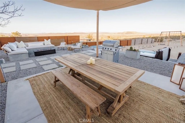 view of patio / terrace featuring outdoor dining space, fence, an outdoor hangout area, and area for grilling