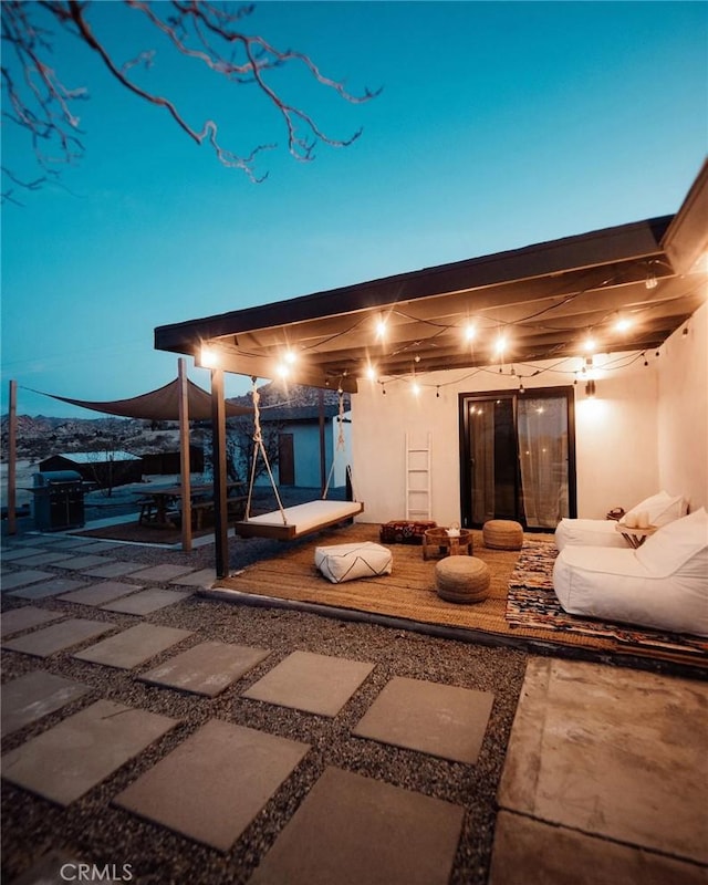 back of house featuring a patio area and stucco siding