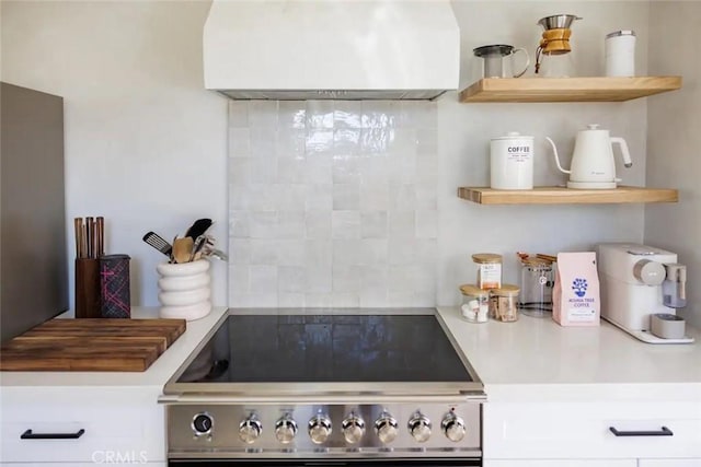 kitchen with open shelves, range, and light countertops