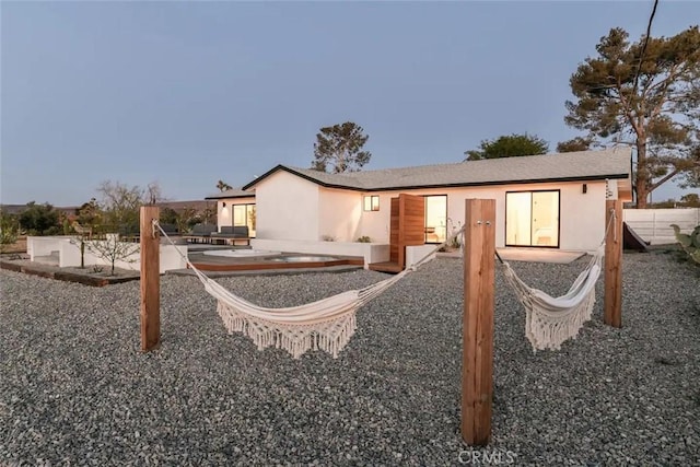 rear view of property with a patio area and stucco siding