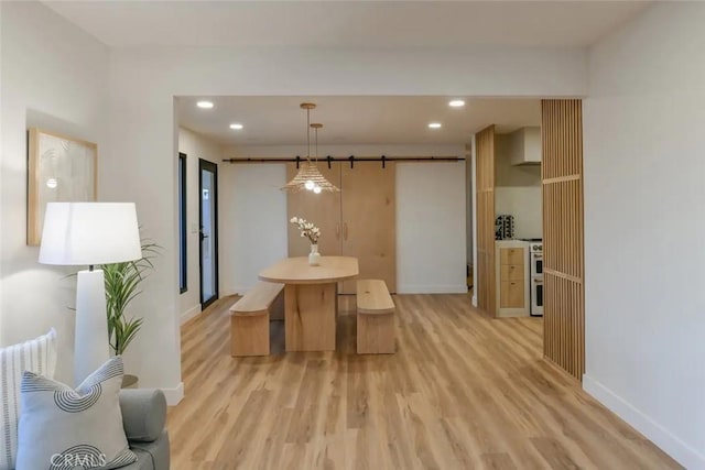 dining space with light wood-type flooring, baseboards, and recessed lighting