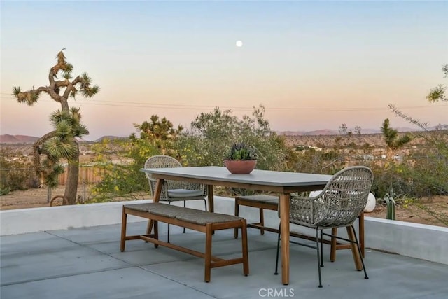 patio terrace at dusk with outdoor dining area