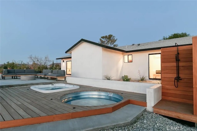 view of swimming pool with an in ground hot tub, a wooden deck, and an outdoor living space