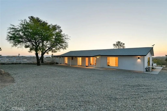 view of front of property featuring cooling unit and fence