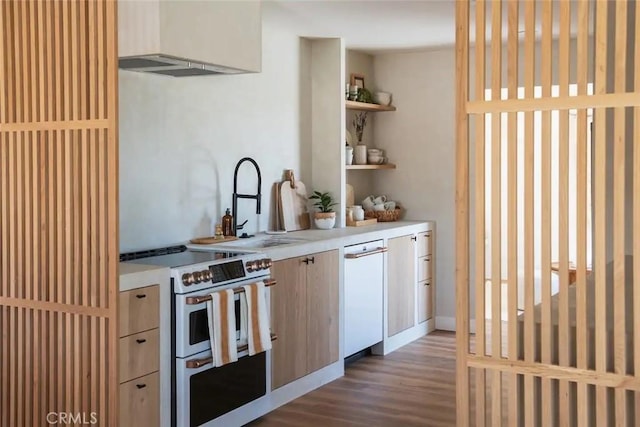 kitchen with open shelves, light countertops, a sink, wood finished floors, and double oven range