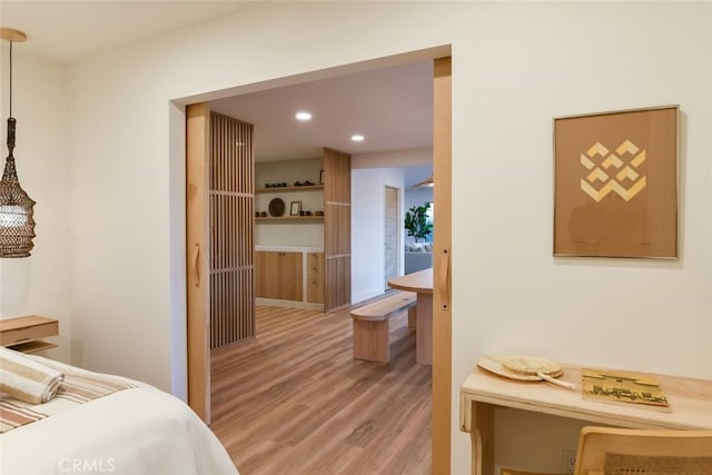 bedroom with light wood finished floors and recessed lighting