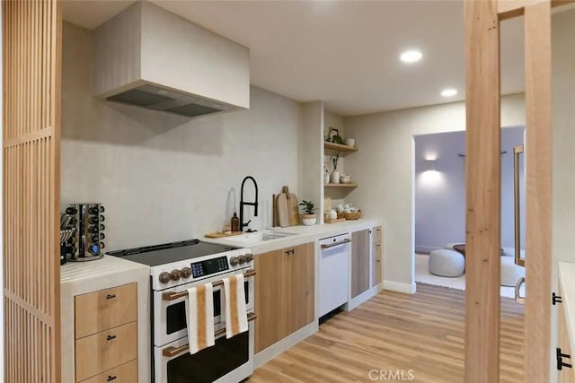 kitchen featuring open shelves, custom range hood, light wood-style flooring, a sink, and white appliances