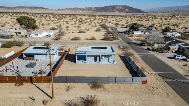 drone / aerial view featuring view of desert and a mountain view