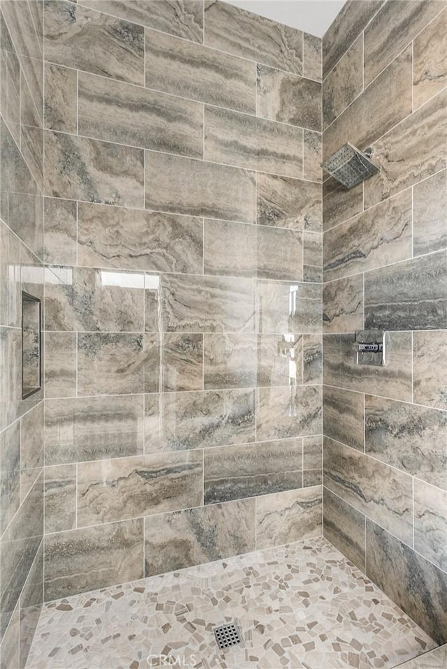 bathroom with tiled shower