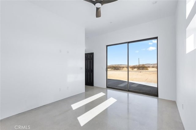 unfurnished room with concrete floors and a ceiling fan