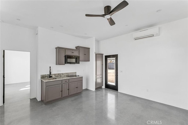 kitchen featuring a sink, a ceiling fan, a wall mounted AC, gray cabinets, and black appliances