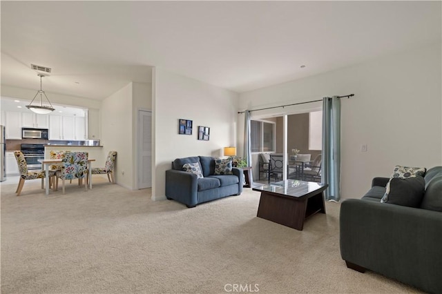 living area with light colored carpet and visible vents