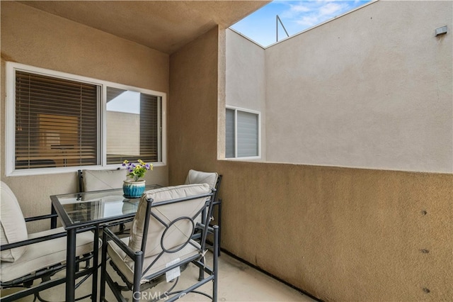 balcony featuring outdoor dining area and a patio area