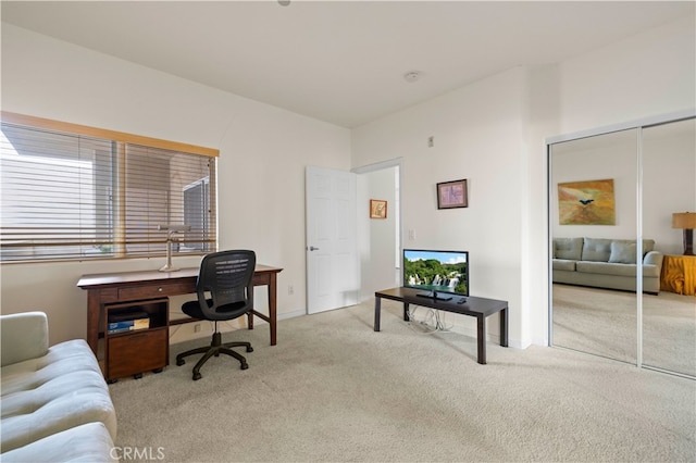 carpeted home office with baseboards