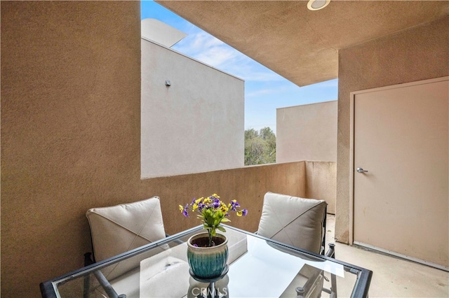 view of patio featuring a balcony