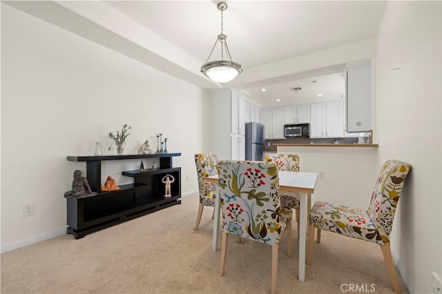 dining space with recessed lighting, baseboards, light carpet, and visible vents