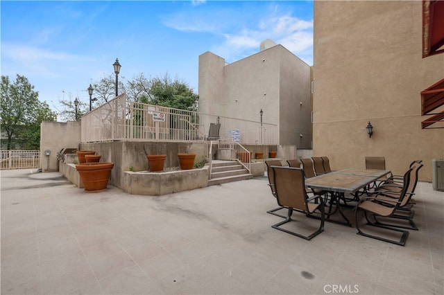 view of patio / terrace with outdoor dining space and fence