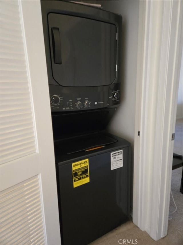 interior details featuring stacked washer and dryer