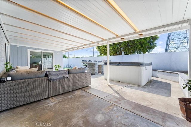 view of patio featuring outdoor lounge area, a fenced backyard, and a hot tub