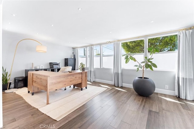 home office featuring wood finished floors and baseboards