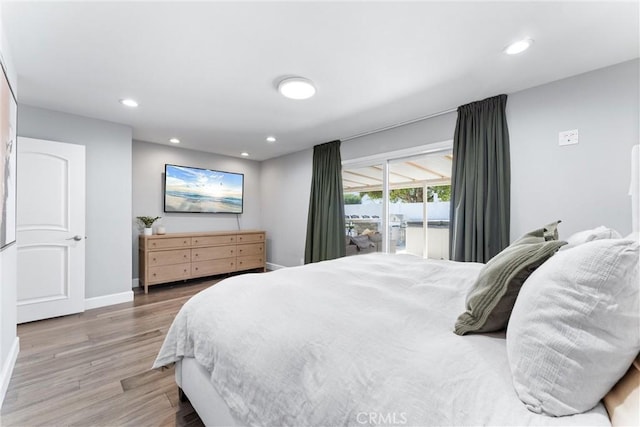 bedroom with access to outside, baseboards, wood finished floors, and recessed lighting