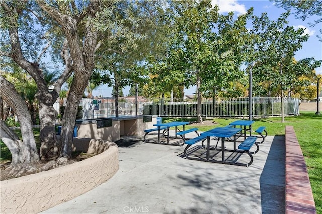 view of home's community with a patio area and fence