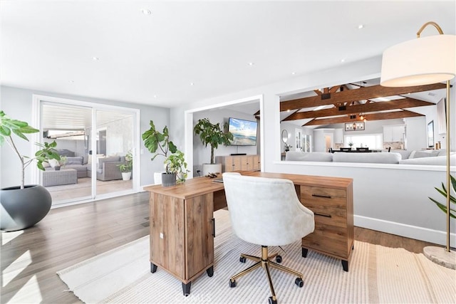 office area featuring wood finished floors and beam ceiling