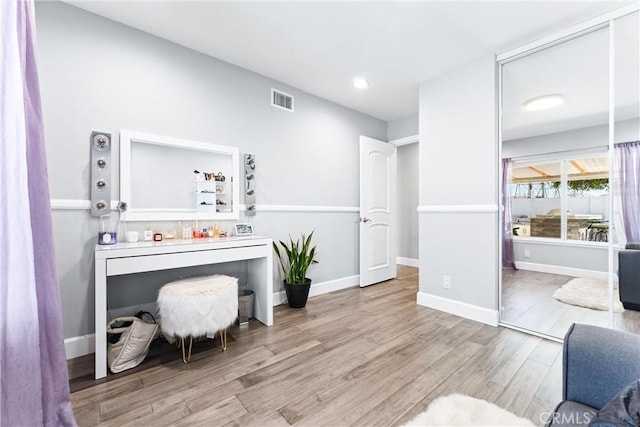 interior space featuring wood finished floors, visible vents, and baseboards