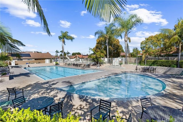 pool with fence and a patio