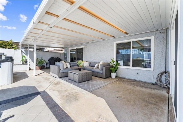 view of patio featuring a grill, fence, and an outdoor hangout area