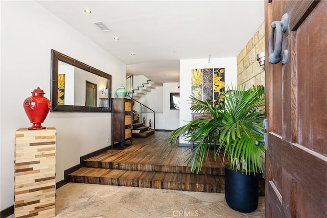 hallway featuring stairs, recessed lighting, visible vents, and baseboards