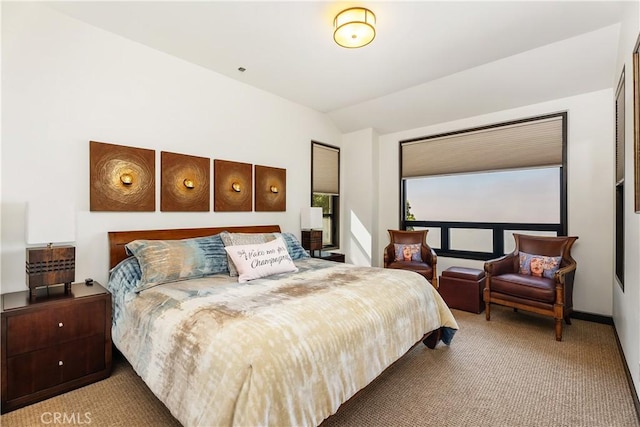 carpeted bedroom featuring lofted ceiling