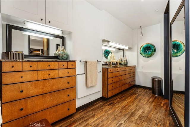 bedroom featuring baseboards and dark wood-style floors