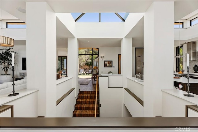 staircase with a high ceiling and wood finished floors