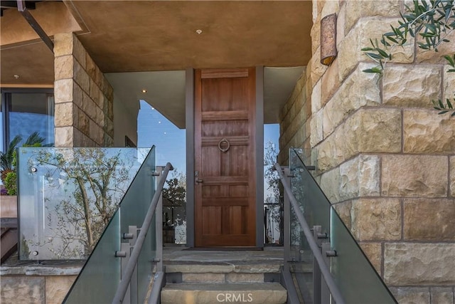 entrance to property featuring stone siding
